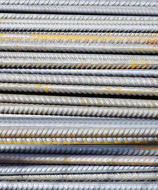 Close-up of stacked rusty steel reinforcing bars used in construction.