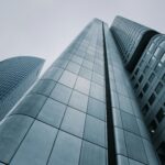 Low angle view of modern skyscrapers with glass and steel design. Perfect for corporate imagery.